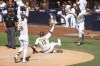 From left to right, San Diego Padres' Jose Azocar, Manny Machado and Jorge Alfaro celebrate after Machado slid into home plate on a throwing error by Colorado Rockies' Elias Diaz in the 10th inning of the first game of a baseball doubleheader Saturday June 11, 2022, in San Diego. (AP Photo/Mike McGinnis)