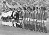 FILE - The teams from West Germany, in white shirts, and East Germany line up for the national anthems before the start of the Football World Cup Group 1 match at the Volksparkstadion, in Hamburg, on June 22, 1974. East German captain Bernd Bransch at center holding flag. Bernd Bransch, who captained East Germany at its only World Cup appearance in a symbolic Cold War win over West Germany, has died. He was 77. Bransch's former club Hallescher FC said in a statement Sunday June 12, 2022 that he had died on Saturday following “a long, severe illness.