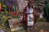 A shaman stands next a photo of Australia's national soccer team, on San Cristobal hill in Lima, Peru, Friday, June 10, 2022. Shamans called on Mother Earth to support Peru in its play-off game against Australia on Monday, to seal one of the final spots in this year's World Cup in Qatar. (AP Photo/Martin Mejia)