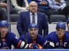 FILE - New York Islanders head coach Barry Trotz, top, looks on in the third period of an NHL hockey game against the Minnesota Wild, Jan. 30, 2022, in Elmont, N.Y. A Winnipeg brewery says it will give Trotz free beer for life if he returns to his native province to coach the Jets. (AP Photo/Adam Hunger, File)