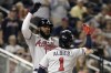 Atlanta Braves' Marcell Ozuna, left, celebrates with teammate Ozzie Albies (1) after hitting a two-run home run during the third inning of a baseball game against the Washington Nationals, Monday, June 13, 2022, in Washington. (AP Photo/Luis M. Alvarez)