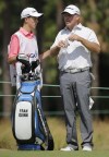 FILE - Fran Quinn, right, talks with his caddie and son Owen Quinn on the eighth hole during the second round of the U.S. Open golf tournament in Pinehurst, N.C., Friday, June 13, 2014. Fran Quinn knew his odds of making the U.S. Open weren’t great. He’s 57. But when his 23-year-old son, Owen, said he was going to enter qualifying, Fran figured that with the tournament happening right down the road from his house this year, it might be worth it.(AP Photo/Eric Gay, File)