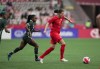 Canada's Christine Sinclair (12) moves the ball while being watched by Nigeria's Toni Payne (7) during the first half of a women's friendly soccer match, in Vancouver, on Friday, April 8, 2022. Canada Soccer has named its squad for the beginning of the upcoming June women's international window.Star striker Christine Sinclair will again serve as team captain.THE CANADIAN PRESS/Darryl Dyck