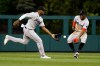 Miami Marlins' Jorge Soler, left, fields a ball hit by Philadelphia Phillies' Rhys Hoskins as Jesus Sanchez watches during the third inning of a baseball game Tuesday, June 14, 2022, in Philadelphia. (AP Photo/Matt Rourke)