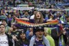 A young Seattle Sounders supporter holds a rainbow flag before an MLS soccer match between the Sounders and the Vancouver Whitecaps, Tuesday, June 14, 2022, in Seattle during Pride Month. (AP Photo/Ted S. Warren)