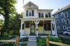 The boyhood home of Francis Ouimet, the self-taught former caddie who won the 1913 U.S. Open golf tournament, stand across the street from The Country Club, Tuesday, June 14, 2022, in Brookline, Mass. Period furniture has been brought in to decorate the house, with artwork celebrating Ouimet and his role as the founding father of American golf. (AP Photo/Robert F. Bukaty)