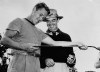 FILE - Lew Worsham, left, takes a good look at the putter that Sam Snead, right, used to sink a 20-foot putt on the last hole to force a playoff in the U.S. Open golf tournament June 14, 1947, at St. Louis Country Club in Ladue, Mo. This is the 75-year anniversary of Worsham winning the U.S. Open. (AP Photo/File)