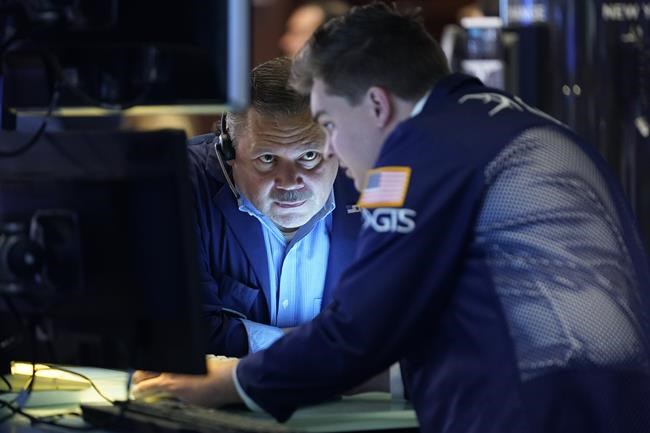Traders work on the floor at the New York Stock Exchange in New York, Wednesday, June 15, 2022. U.S. stocks are rallying Wednesday and are on track for their first gain in six days. But more turbulence may be ahead when the Federal Reserve announces in the afternoon how sharply it's raising interest rates. (AP Photo/Seth Wenig)