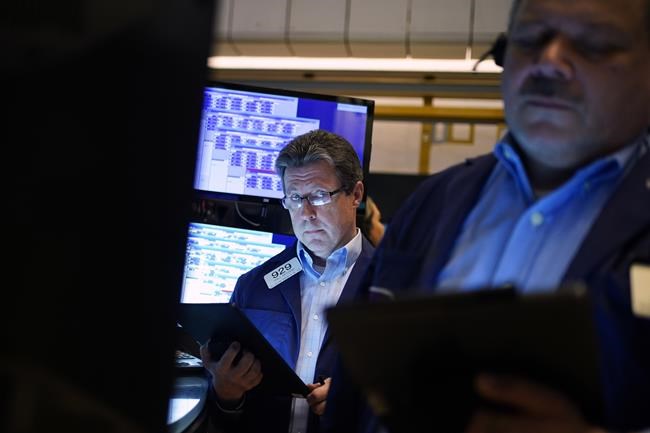 Traders work on the floor at the New York Stock Exchange in New York, Wednesday, June 15, 2022. U.S. stocks are rallying Wednesday and are on track for their first gain in six days. But more turbulence may be ahead when the Federal Reserve announces in the afternoon how sharply it's raising interest rates. (AP Photo/Seth Wenig)