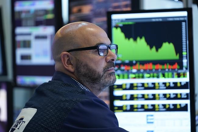 As the Federal Reserve announces a rate change, a trader works on the floor at the New York Stock Exchange in New York, Wednesday, June 15, 2022. (AP Photo/Seth Wenig)