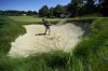 Charles Reiter hits out of a bunker onto the 17th green at The Country Club, Tuesday, June 14, 2022, in Brookline, Mass., during a practice round ahead of the U.S. Open golf tournament. (AP Photo/Robert F. Bukaty)
