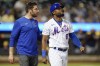 A trainer checks on New York Mets' Starling Marte (6) after Marte was hit by a pitch during the sixth inning of a baseball game against the Milwaukee Brewers, Wednesday, June 15, 2022, in New York. Marte left the game after walking to first base. (AP Photo/Frank Franklin II)