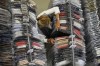 Nadia Zanola, chairman of the 'Cose di Maglia' factory, goes through racks of clothing at a warehouse section of unsold clothes, in Brescia, Italy, Tuesday, June 14, 2022. Small Italian fashion producers are still allowed to export to Russia, despite sanctions, as long as the wholesale price is under 300 euros. But they are having a hard time getting paid, due to restrictions tied to the financial sector. (AP Photo/Luca Bruno)