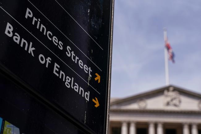 A sign indicates the Bank of England, in the financial district known as The City, in London, Thursday, June 16, 2022. The Bank of England raised interest rates by a quarter-percentage point Thursday, shrugging off pressure for a bolder move to combat price increases that have pushed inflation to a 40-year high. (AP Photo/Alberto Pezzali)