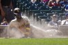San Diego Padres' Jurickson Profar scores in a cloud of dust off a single by Manny Machado during the fourth inning of a baseball game against the Chicago Cubs Thursday, June 16, 2022, in Chicago. (AP Photo/Charles Rex Arbogast)