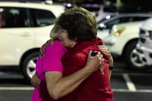 Church members console each other after a shooting at the Saint Stevens Episcopal Church on Thursday, June 16, 2022 in Vestavia, Ala. (AP Photo/Butch Dill)