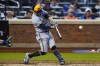 Milwaukee Brewers' Luis Urias hits a single during the fourth inning of the team's baseball game against the New York Mets on Thursday, June 16, 2022, in New York. (AP Photo/Frank Franklin II)