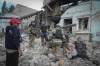 Search and rescue workers and local residents remove a body from under the rubble of a building after a Russian air raid in Lysychansk, Luhansk region, Ukraine, Thursday, June 16, 2022. (AP Photo/Efrem Lukatsky)