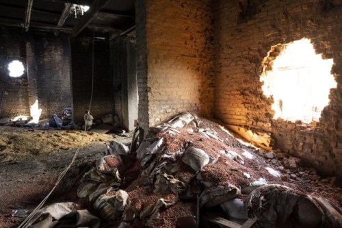 FILE - Scattered grain sits inside a warehouse damaged by Russian attacks in Cherkaska Lozova, outskirts of Kharkiv, eastern Ukraine, Saturday, May 28, 2022. Russian hostilities in Ukraine are preventing grain from leaving the “breadbasket of the world