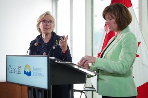Federal Minister of Mental Health and Addictions and Associate Minister of Health Carolyn Bennett, back left, speaks as B.C. Minister of Mental Health and Addictions Sheila Malcolmson listens during a news conference after British Columbia was granted an exemption to decriminalize possession of some illegal drugs for personal use, in Vancouver, on Tuesday, May 31, 2022.&nbsp;As drug users in British Columbia will not be arrested or charged for carrying up to 2.5 grams of illicit drugs starting next year, experts explain why the federal government is being asked to decriminalize drugs in order to stem deaths linked to the drug toxicity crisis in Canada, and what decriminalization means.&nbsp;THE CANADIAN PRESS/Darryl Dyck