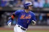 New York Mets' Jeff McNeil runs to first after hitting an RBI single off Miami Marlins starting pitcher Braxton Garrett (60) in the second inning of a baseball game, Saturday, June 18, 2022, in New York. (AP Photo/John Minchillo)
