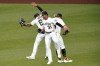 Pittsburgh Pirates outfielders Bligh Madris, left, Cal Mitchell (31) and Jack Suwinski, right, celebrate after getting the final out of a 12-1 win over the Chicago Cubs in a baseball game in Pittsburgh, Monday, June 20, 2022. (AP Photo/Gene J. Puskar)