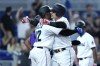 Miami Marlins right fielder Avisail Garcia, right, is met at the plate by Jorge Soler after hitting a three-run home run during the fourth inning of a baseball game against the Colorado Rockies, Tuesday, June 21, 2022, in Miami. (AP Photo/Lynne Sladky)