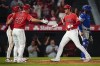 Los Angeles Angels designated hitter Shohei Ohtani (17) celebrates with Mike Trout (27) and Tyler Wade after hitting a home run during the ninth inning of a baseball game against the Kansas City Royals in Anaheim, Calif., Tuesday, June 21, 2022. Trout and Wade also scored. (AP Photo/Ashley Landis)