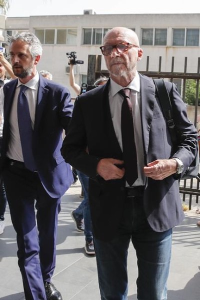 Canadian-born film director Paul Haggis, right, arrives with his lawyer Federico Straziota at Brindisi law court in southern Italy, Wednesday, June 22, 2022, to be heard by prosecutors investigating a woman's allegations he had sex with her without her consent over the course of two days. Under Italian law, a judge, after hearing arguments from both prosecutors and defense lawyers, will rule on whether Haggis can be set free pending possible additional investigation. (AP Photo/Salvatore Laporta)