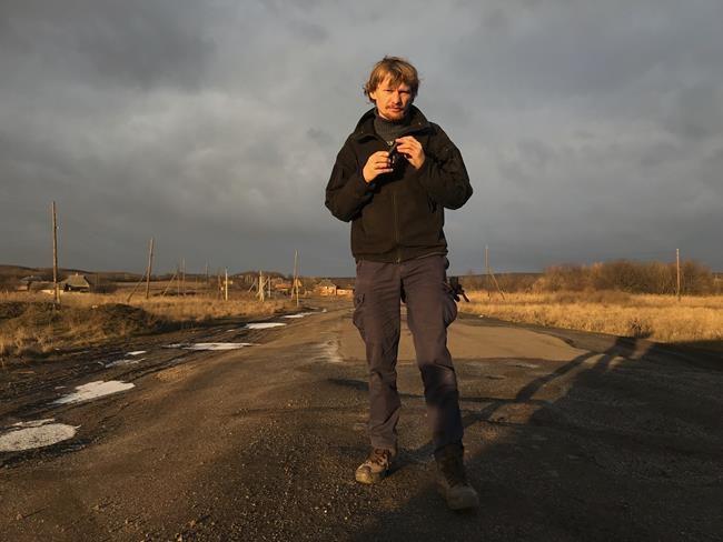 FILE - Ukrainian photojournalist Maks Levin poses for a photo in the Donetsk region in Ukraine on Jan. 12, 2018. The press freedom group Reporters Without Borders says it believes that Levin and a soldier who was accompanying him were