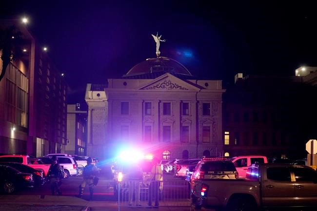 A large number of police surround the Arizona Capitol after protesters reached the front of the AZ Senate building following the Supreme Court's decision to overturn Roe v. Wade Friday, June 24, 2022, in Phoenix. (AP Photo/Ross D. Franklin)
