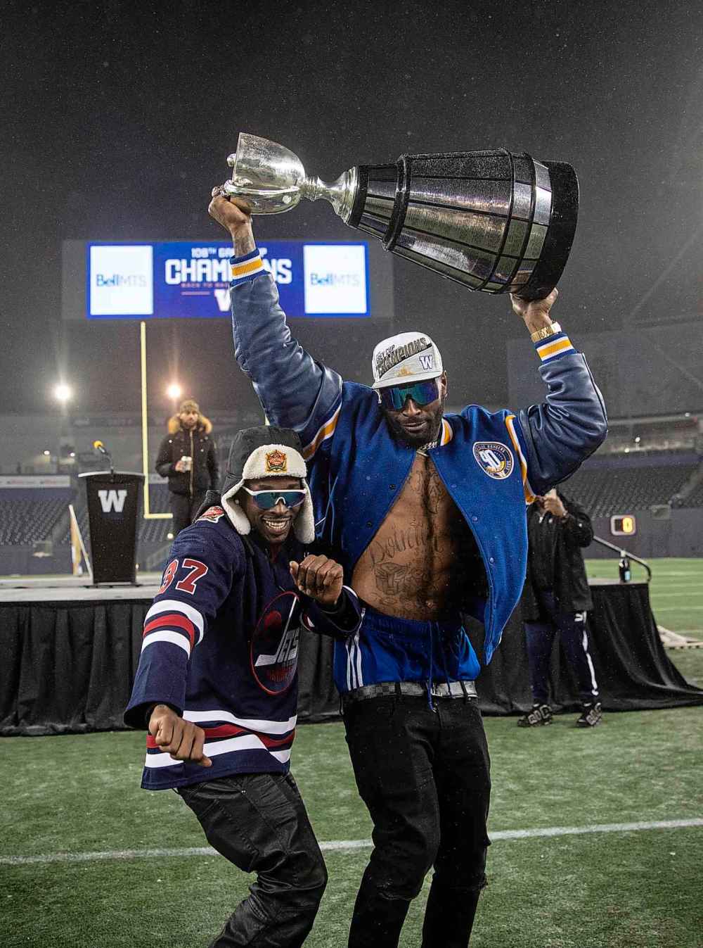Bombers players Winston Rose (left) and Willie Jefferson celebrate the win with some dance moves. (Jessica Lee / Winnipeg Free Press)