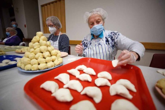 Sopia Kitasz places a pinched perogy onto her tray while a pyramid of balls of mashed potato wait to be made into perogies. (Mike Deal / WInnipeg Free Press files)