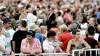 Throngs of spectators wait near the Scotiabank stage at The Forks for the guest of honour.