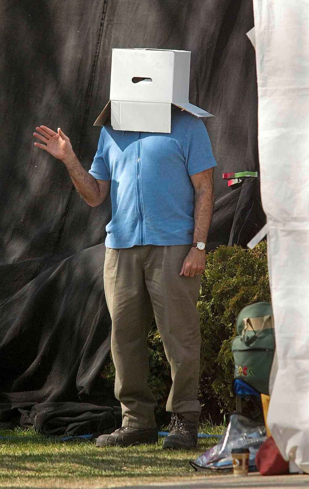 Actor and comedian Robin Williams wears a box on his head to joke around with photographers during a break while shooting the movie The Big White in 2004.