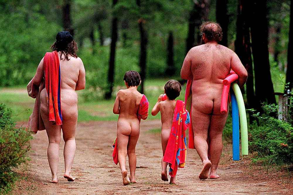 A family attends an open house at a nudist camp near Libau, Man., in 1997.