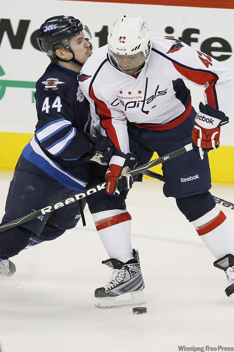 John Woods / Winnipeg Free Press
Winnipeg Jets' defenceman Artus Kulda (44) attempts to hold back Washington Capitals' forward Joel Ward (42) during first period NHL action in Winnipeg on Thursday.
