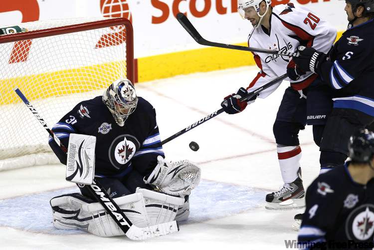 John Woods / Winnipeg Free Press
Winnipeg Jets' goalie Ondrej Pavelec (31) saves the shot from Washington Capitals' forward Troy Brouwer (20) during third period NHL action in Winnipeg on Thursday.