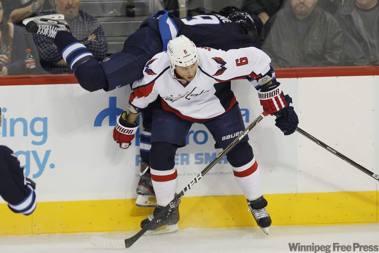 John Woods / Winnipeg Free Press
Winnipeg Jets' forward Evander Kane (9) gets checked by Washington Capitals defenseman Dennis Wideman (6) during first period NHL action in Winnipeg on Thursday.