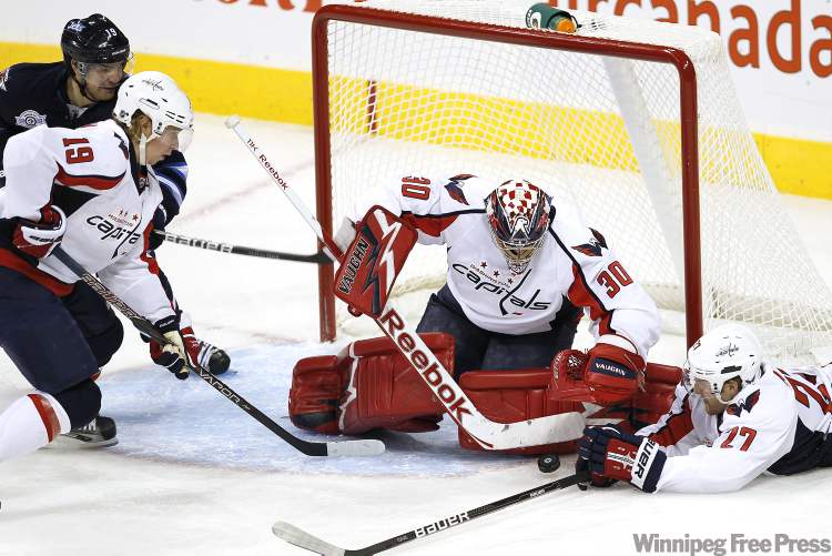 John Woods / Winnipeg Free Press
Washington Capitals' goalie Michal Neuvirth (30) and defenceman Karl Alzner (27) rob Winnipeg Jets forward Jim Slater (19) of the puck during first period NHL action in Winnipeg on Thursday.