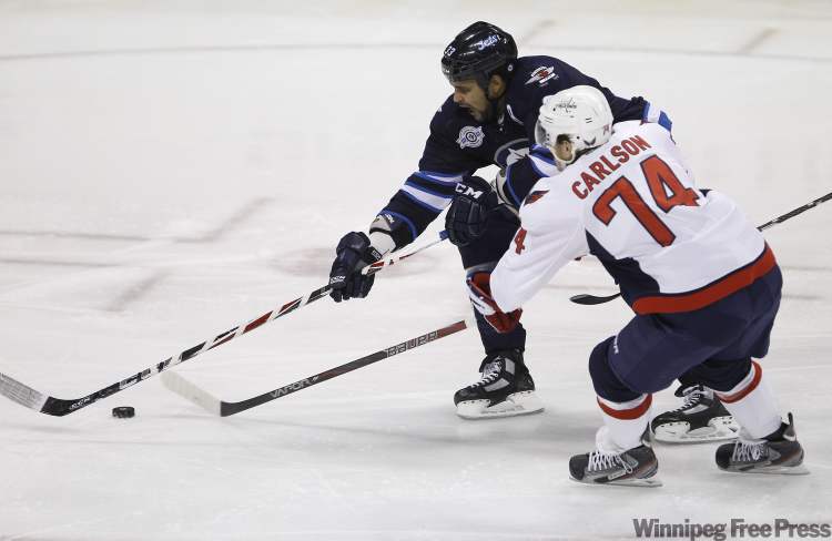 Trevor Hagan / The Canadian Press
Winnipeg Jets' Dustin Byfuglien (33) chases the puck around Washington Capitals' John Carlson (74) during first period NHL action at MTS Centre in Winnipeg Thursday.
