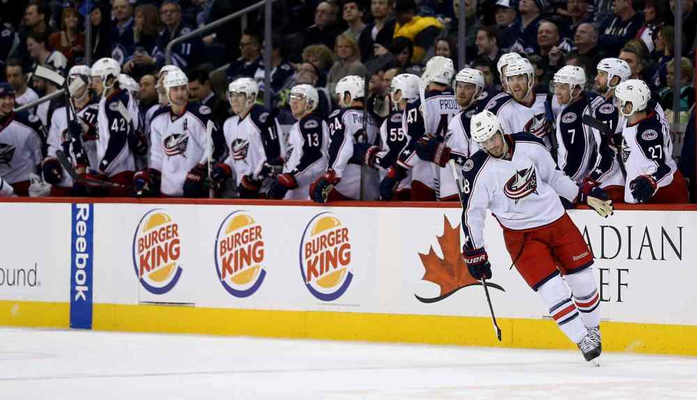 Trevor Hagan / Winnipeg Free Press
Columbus Blue Jackets' Boone Jenner (38) celebrates with his team after he scored a penalty shot goal against Winnipeg Jets' goaltender Ondrej Pavelec (31) in the second period at MTS Centre.