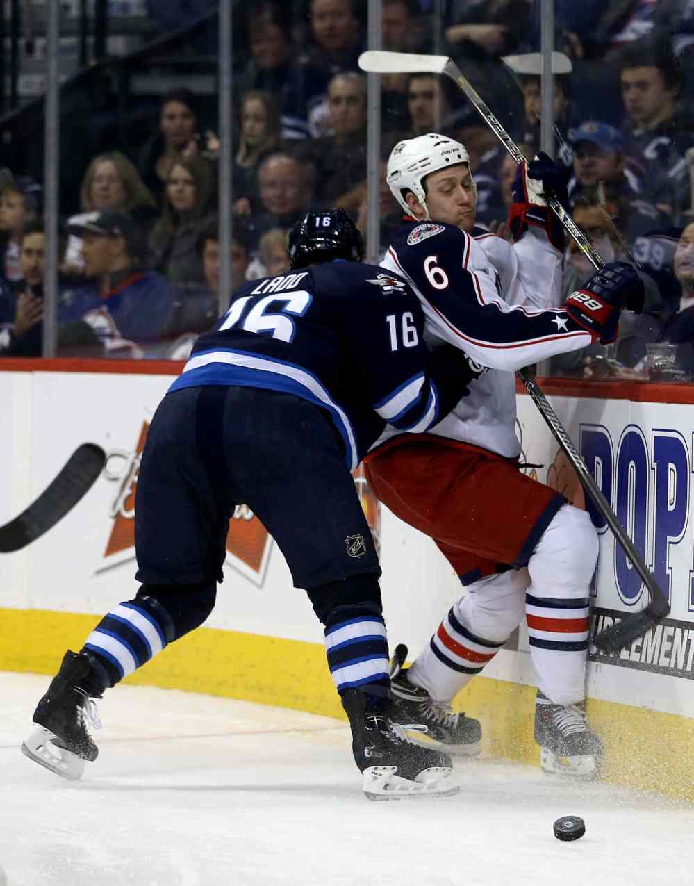 Trevor Hagan / Winnipeg Free Press
Winnipeg Jets' Andrew Ladd (16) hits Columbus Blue Jackets' Nikita Nikitin (6) into the boards during second period NHL hockey action in Winnipeg Saturday.