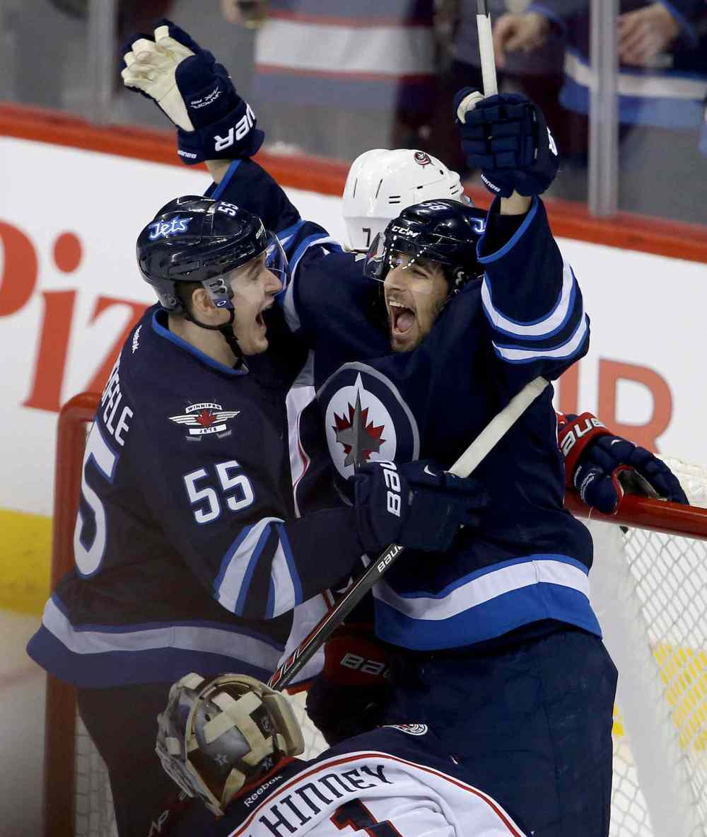 Trevor Hagan / Winnipeg Free Press
Winnipeg Jets' Mark Scheifele (55) and Eric O'Dell (58) celebrate after O'Dell scored his first career NHL goal, during first period NHL hockey action against the Columbus Blue Jackets.