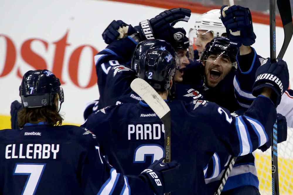 Trevor Hagan / Winnipeg Free Press
Winnipeg Jets' Keaton Ellerby (7), Adam Pardy (2), Michael Frolik (67) and Mark Scheifele (55) celebrate with Eric O'Dell (58) after he scored his first career NHL goal.