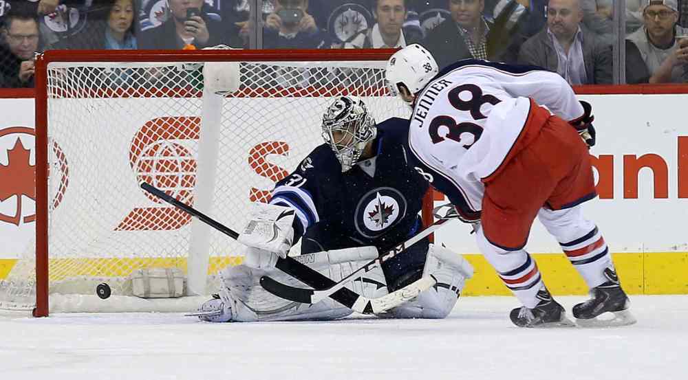 Trevor Hagan / Winnipeg Free Press
Columbus Blue Jackets' Boone Jenner (38) scores a penalty shot goal against Winnipeg Jets' goaltender Ondrej Pavelec (31) during the second period Saturday.