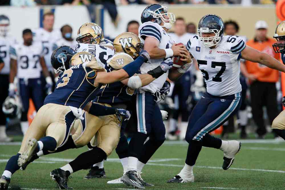 JOHN WOODS / WINNIPEG FREE PRESS
Winnipeg Blue Bombers defensive lineman Greg Peach is the lead tackler as the Bombers defence sacks Toronto Argonauts quarterback Mitchell Gale during the first half of a CFL pre-season game at Investors Group Field in Winnipeg Monday.