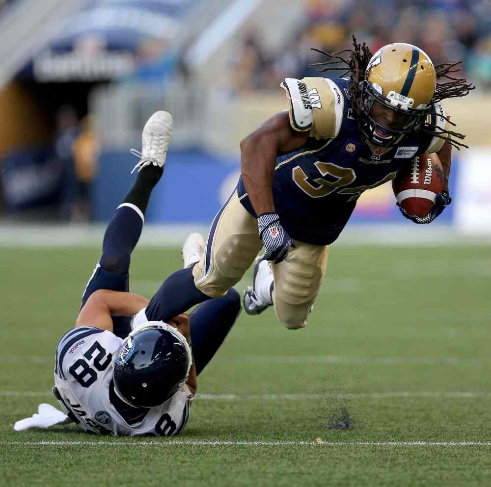 TREVOR HAGAN / THE CANADIAN PRESS
Argonauts defender Josh Jasper brings down Bombers running back/kick returner Paris Cotton during the first half of pre-season CFL football action at Investors Group Field.