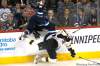 John Woods / WINNIPEG FREE PRESS
Winnipeg Jets' forward Evander Kane (9) gets upended by  Boston Bruins' defenceman Johnny Boychuk (55) during first-period NHL action in Winnipeg on Tuesday.