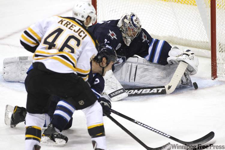 John Woods / Winnipeg Free Press
Winnipeg Jets' goaltender Ondrej Pavelec (31) gets a toe on Boston Bruins' forward David Krejci (46) shot as Jets' defenceman Mark Stuart (5) covers for the rebound during second-period NHL action in Winnipeg on Tuesday.